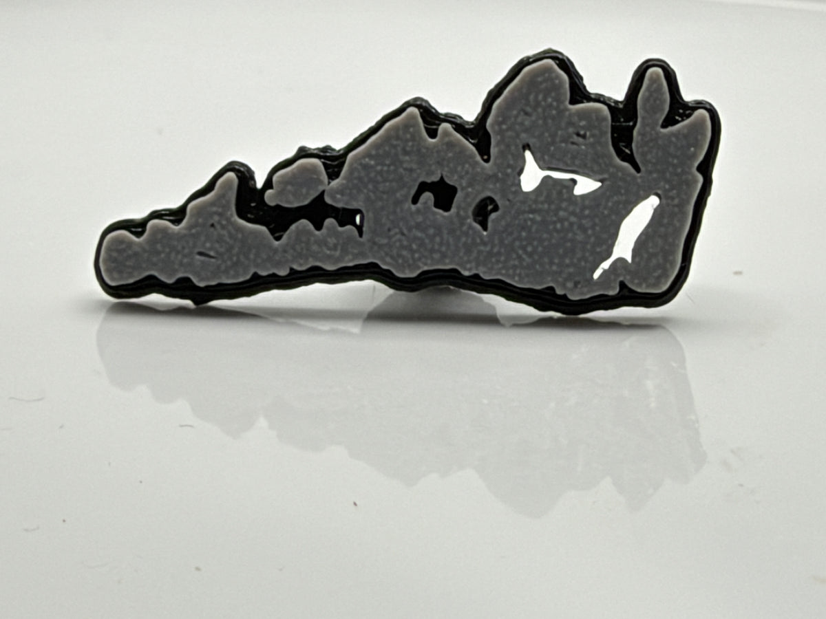 Gray Manitoulin Island shoe charm outside its bag